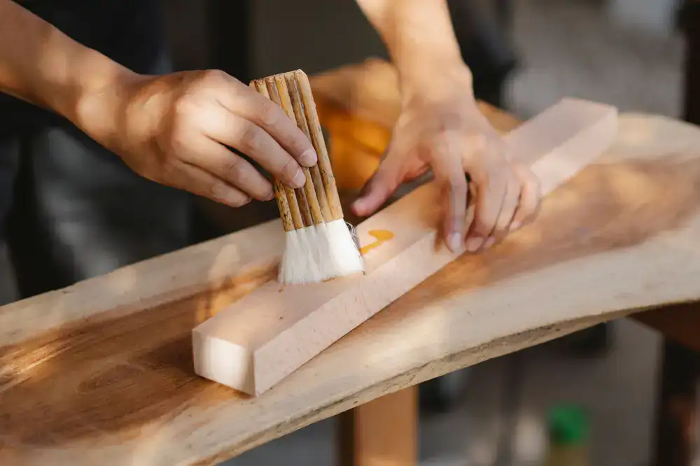 Wood being hand-rubbed with natural finishing oil to bring out its color