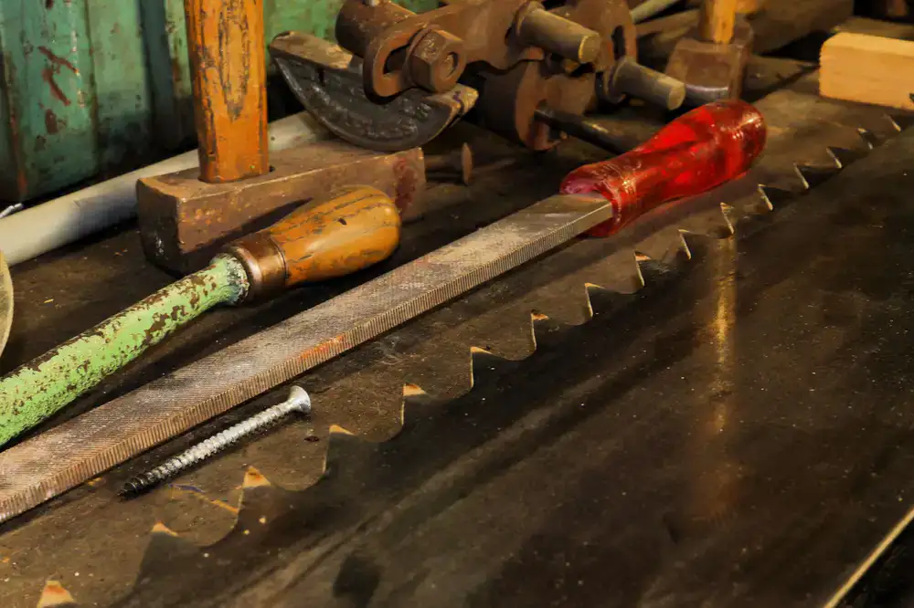 Sunlight streaming onto a heavy wooden workbench covered in hand tools